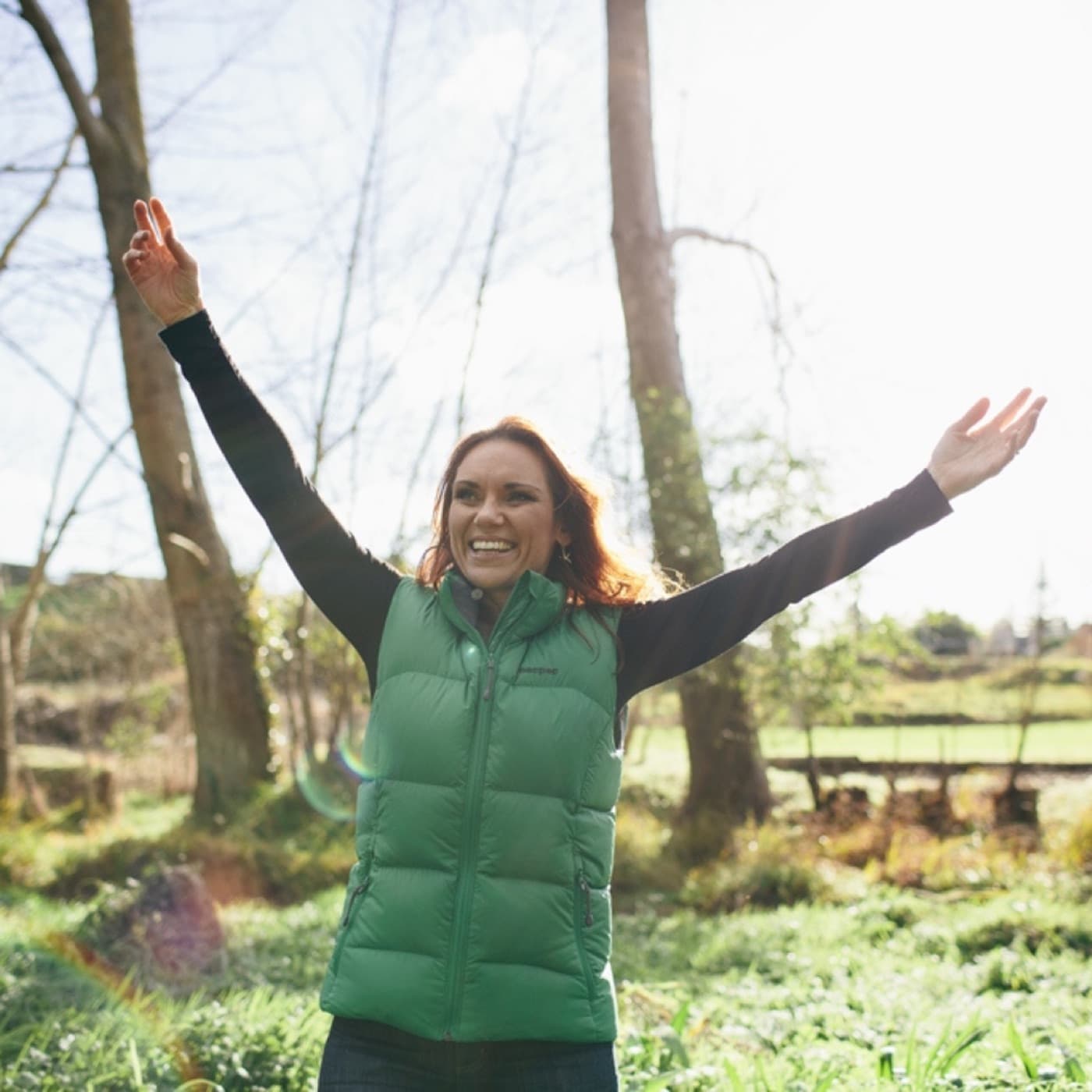 Tracey Hancock outdoors with arms raised